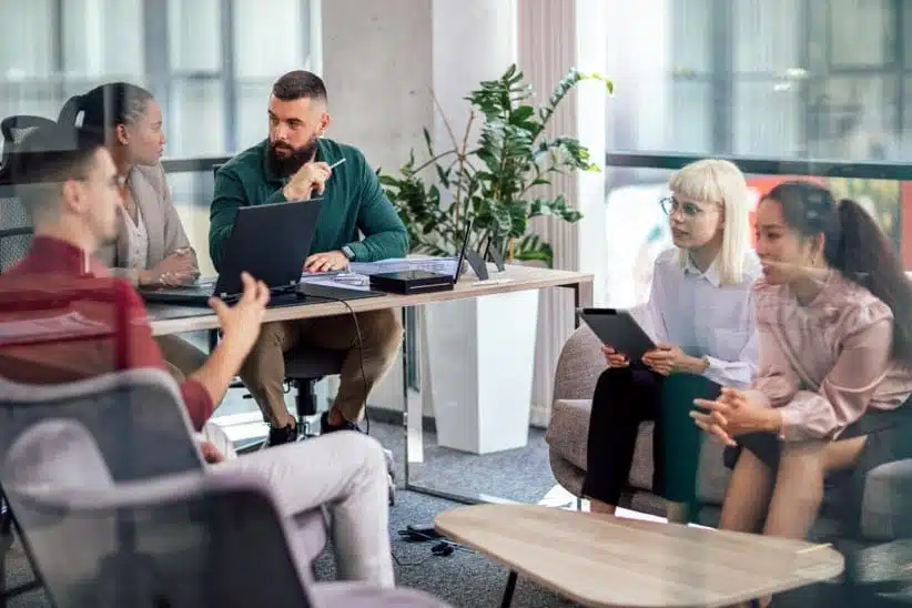 Office colleagues having a discussion in office conference room