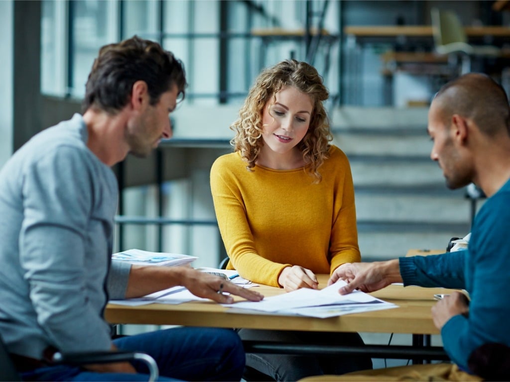 Clients Discussing Referral Program in Conference Room